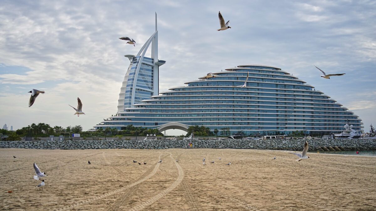 Seagulls fly over the beach with the Burj Al Arab and Jumeirah Marsa Al Arab hotels in the background in Dubai, United Arab Emirates, Thursday, March 12, 2026. (AP Photo/ Fatima Shbair)
