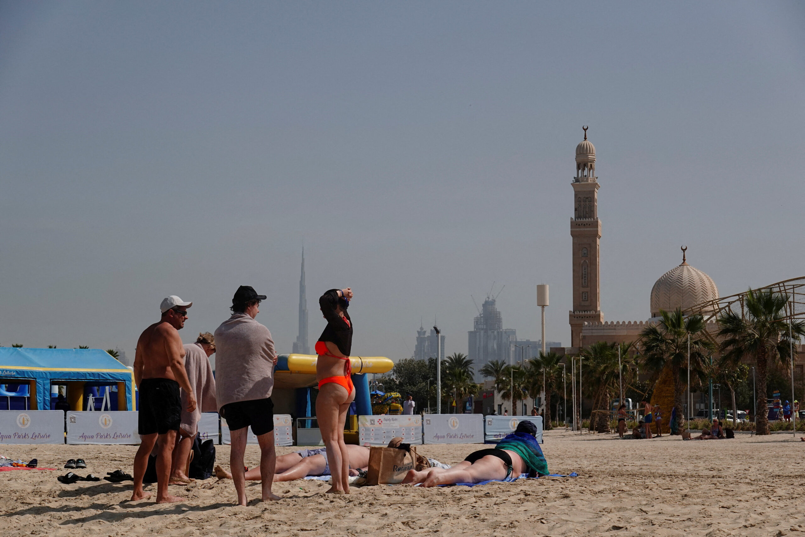 People relax at the Kite Beach with Burj Khalifa in the background, after an Iranian attack, following United States and Israel strikes on Iran, in Dubai, United Arab Emirates, March 1, 2026. REUTERS/Amr Alfiky REFILE - CHANGING HEADLINE