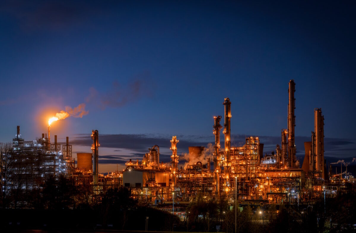 Smoke in the sky from a large flare stack at at Grangemouth petrochemical plant in central Scotland, photographed during the blue hour following sunset.