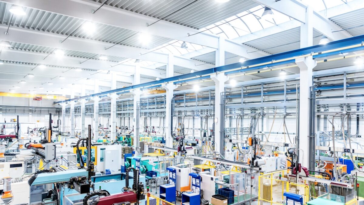 Horizontal color image of large group of modern machines in new factory.