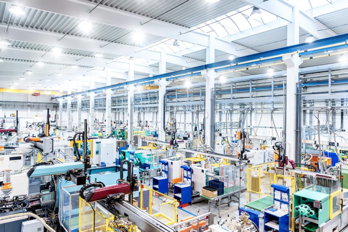 Horizontal color image of large group of modern machines in new factory.