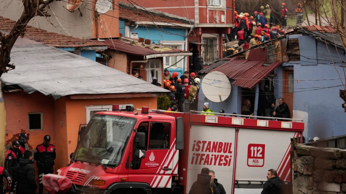 Rescue teams and firefighters search the site where two residential buildings collapsed in Istanbul, Sunday, March 22, 2026. (AP Photo/Khalil Hamra)
