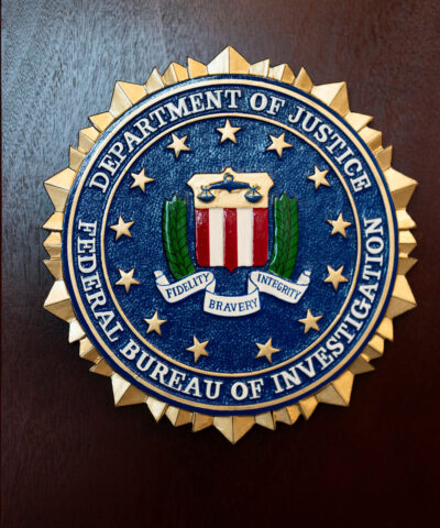 FILE - An FBI seal is displayed on a podium before a news conference at the field office in Portland, Ore., Jan. 16, 2025. (AP Photo/Jenny Kane, File)