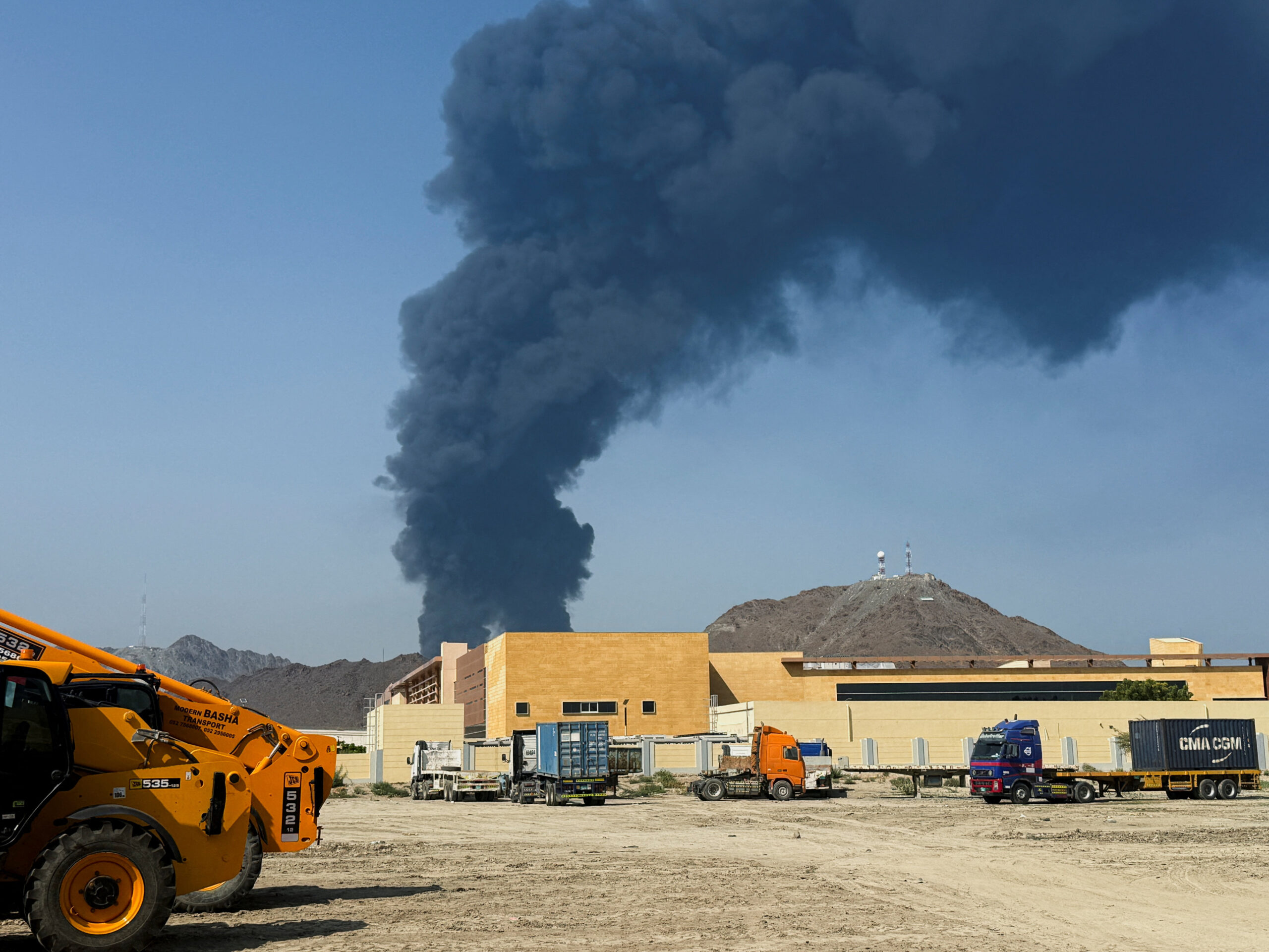 Smoke rises in the Fujairah oil industry zone, caused by debris after interception of a drone by air defenses, according to the Fujairah media office, amid the U.S.-Israel conflict with Iran, in Fujairah Smoke rises in the Fujairah oil industry zone, caused by debris after interception of a drone by air defenses, according to the Fujairah media office, amid the U.S.-Israel conflict with Iran, in Fujairah, United Arab Emirates, March 14, 2026. Picture taken with a mobile phone. REUTERS/Staff