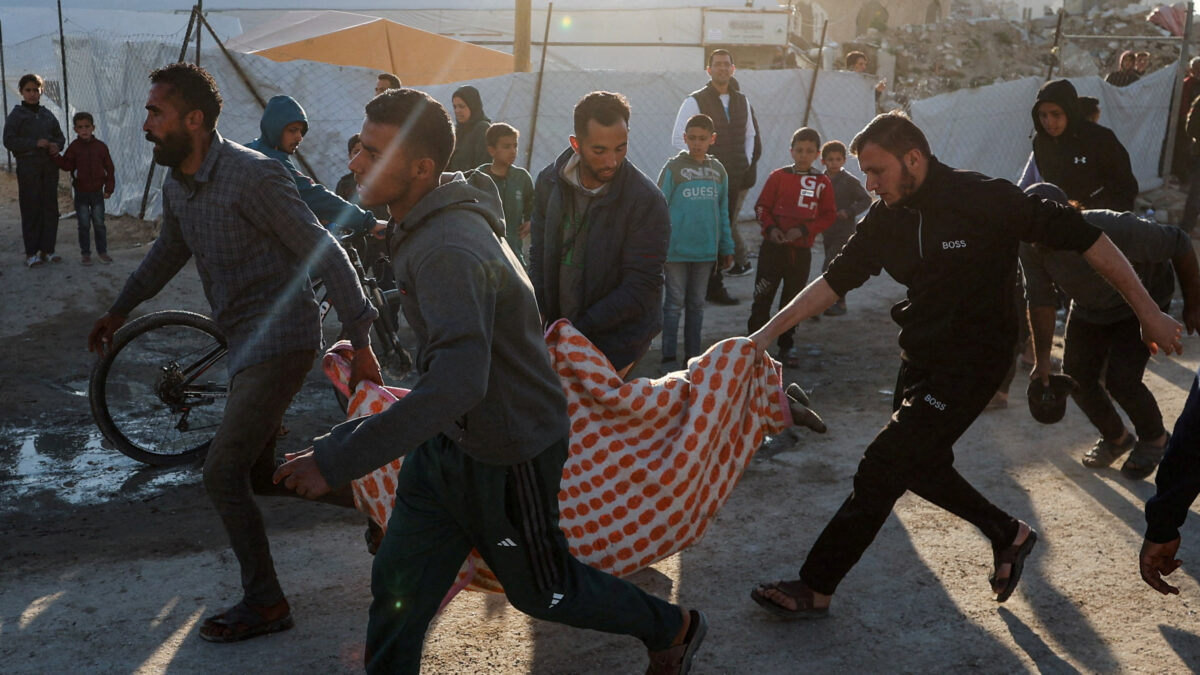 Palestinians carry a casualty at the site hit by an Israeli strike, according to health officials, in Gaza City, March 8, 2026. REUTERS/Dawoud Abu Alkas TPX IMAGES OF THE DAY