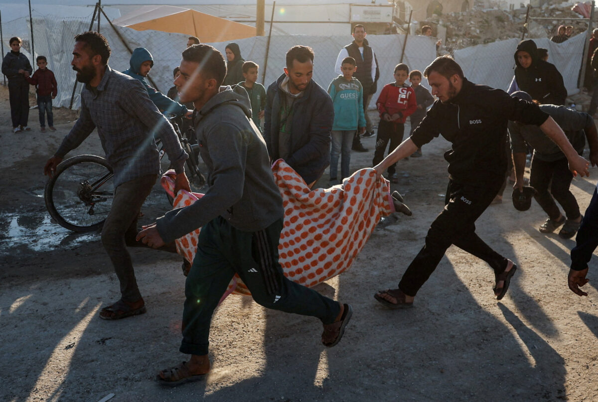 Palestinians carry a casualty at the site hit by an Israeli strike, according to health officials, in Gaza City, March 8, 2026. REUTERS/Dawoud Abu Alkas TPX IMAGES OF THE DAY