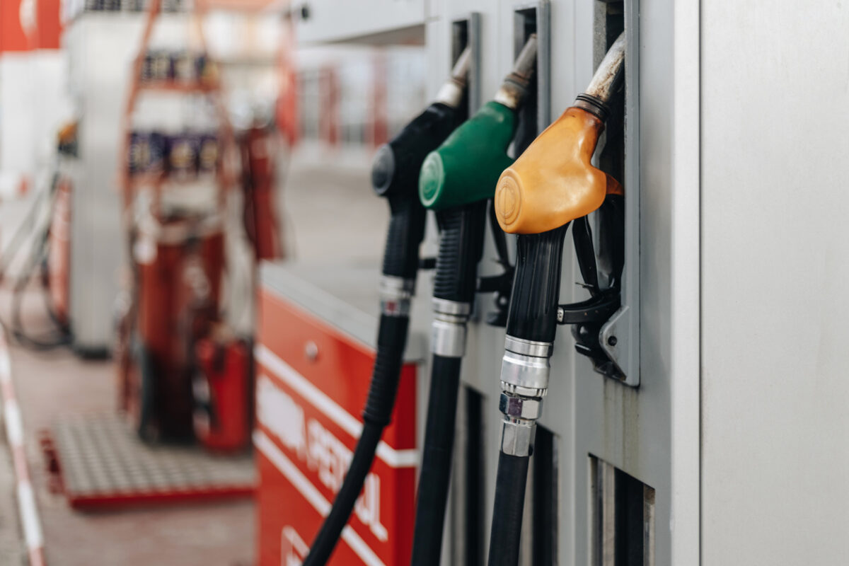 Colorful Petrol pump filling nozzles at bright sunnz day. Gas station background.