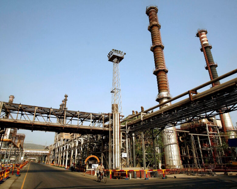 FILE PHOTO: FILE PHOTO: A worker rides a bicycle at the Bharat Petroleum Corporation Ltd. refinery in Mumbai April 24, 2008. REUTERS/Punit Paranjpe/File Photo/File Photo/File Photo