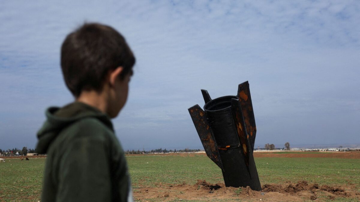 A child stands next to a missile after it fell near Qamishli International Airport, amid the U.S.-Israeli conflict with Iran, in Qamishli, Syria, March 4, 2026. REUTERS/Orhan Qereman TPX IMAGES OF THE DAY REFILE – REMOVING ATTRIBUTION OF THE MISSILE