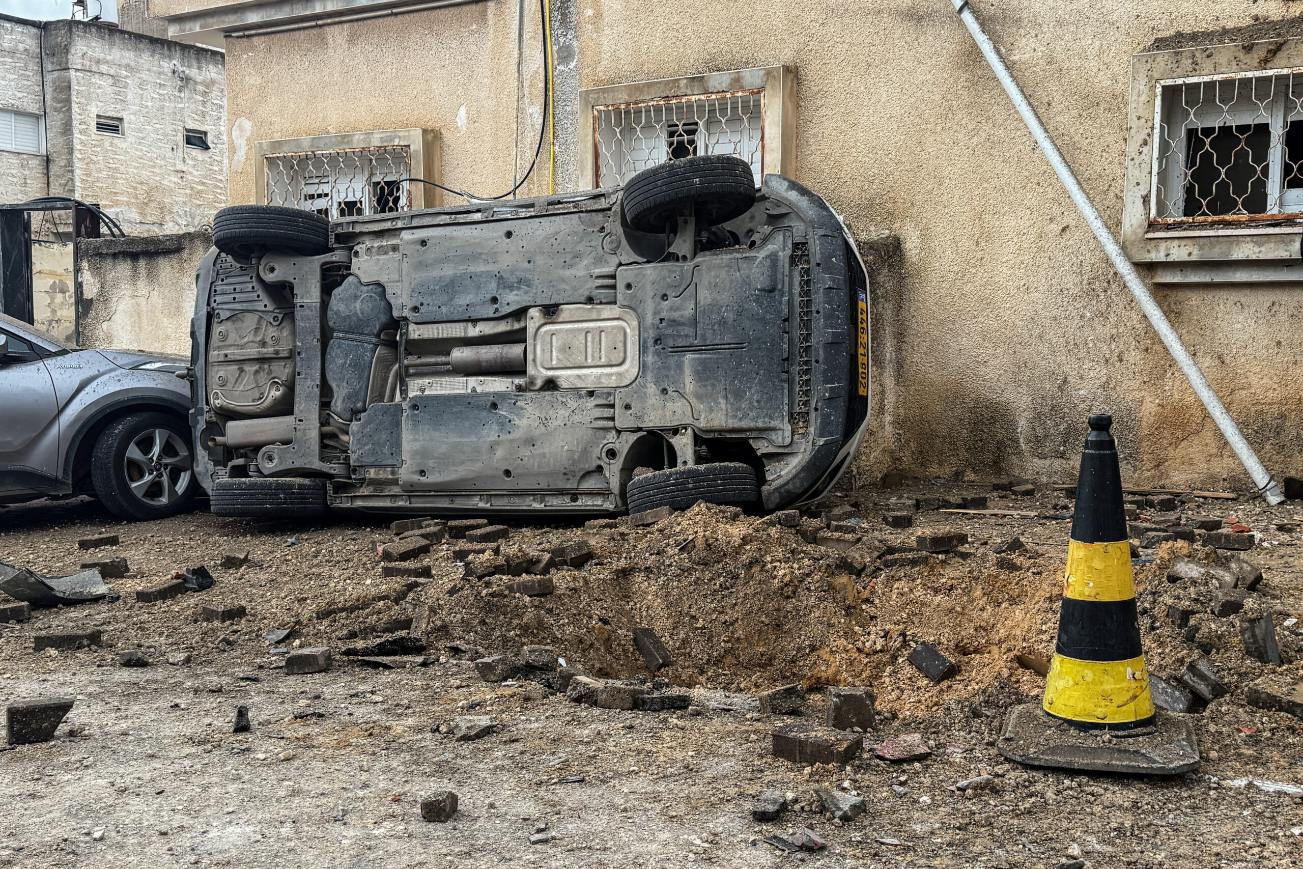 An upturned car at the missile impact site, after Iranian missile barrages were launched at Israel, amid the U.S.-Israel conflict with Iran, in Kafr Qassem REUTERS/Rami Amichay