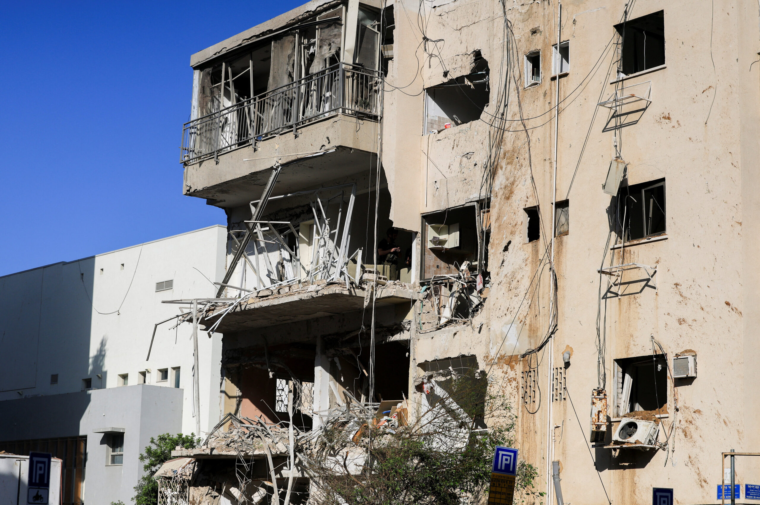 Aftermath of Iranian missile barrages in central Israel Debris hangs from a damaged building at the site following Iranian missile barrages in central Israel, amid the U.S.-Israel conflict with Iran, in Tel Aviv, Israel, March 24, 2026. REUTERS/Ronen Zvulun