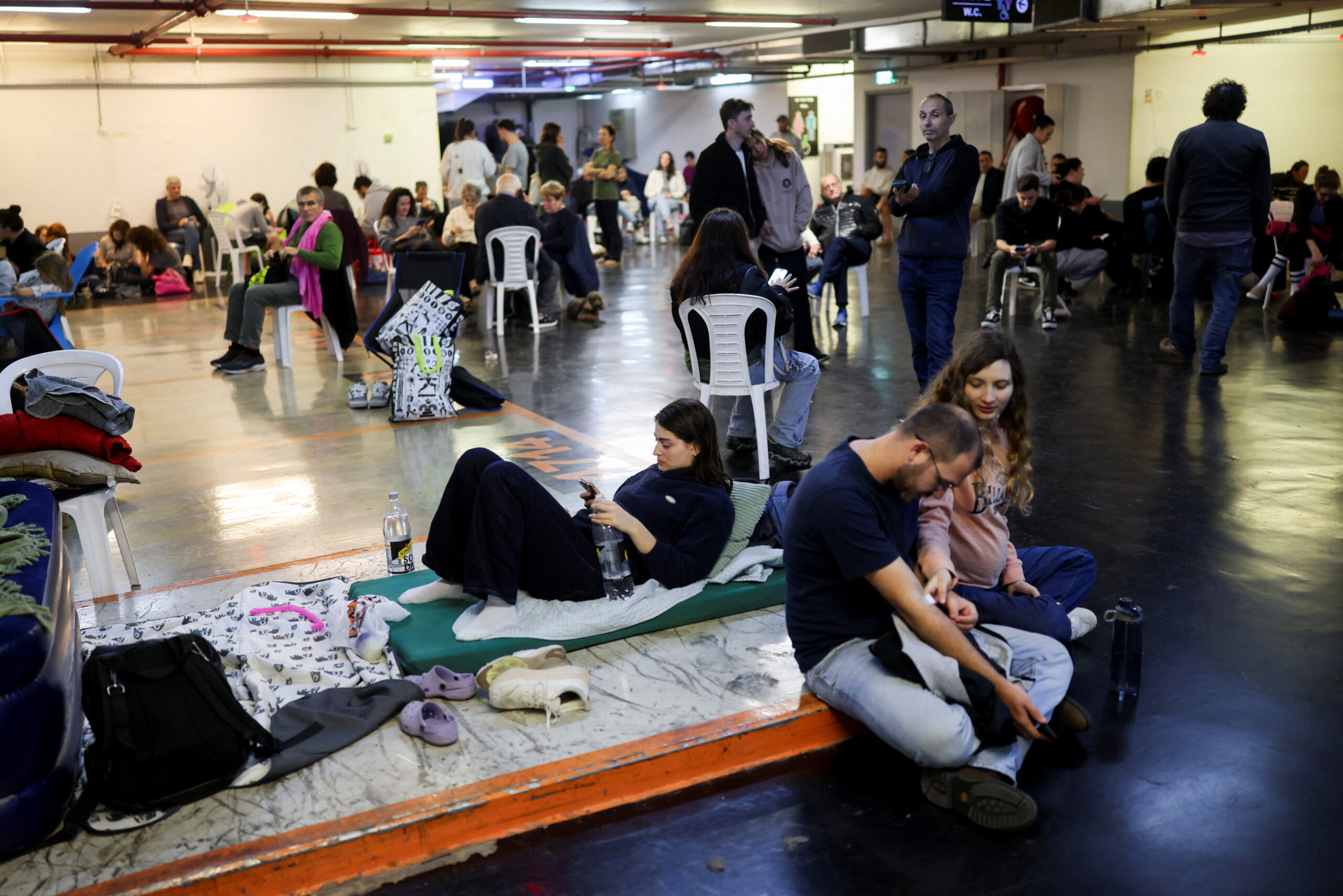Iranian strike, after Israel and the U.S. launched strikes on Iran People take shelter in a parking lot during an Iranian strike, after Iran launched missile barrages following attacks by the U.S. and Israel on Saturday, in Tel Aviv, Israel March 1, 2026. REUTERS/Ronen Zvulun