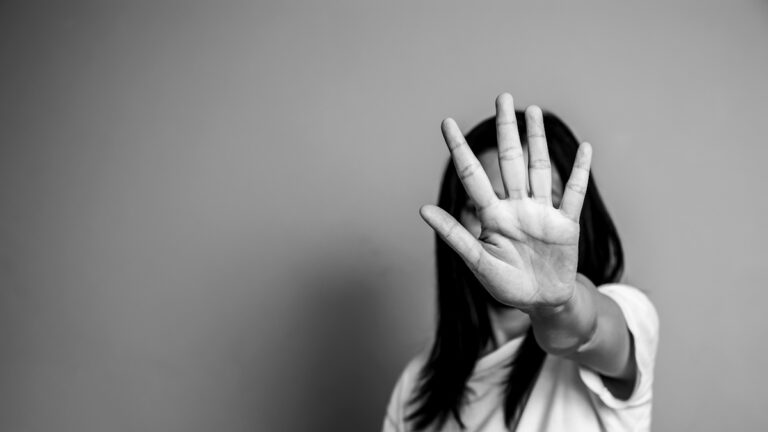 woman raised her hand for dissuade, campaign stop violence against women. Asian woman raised her hand for dissuade with copy space, black and white color