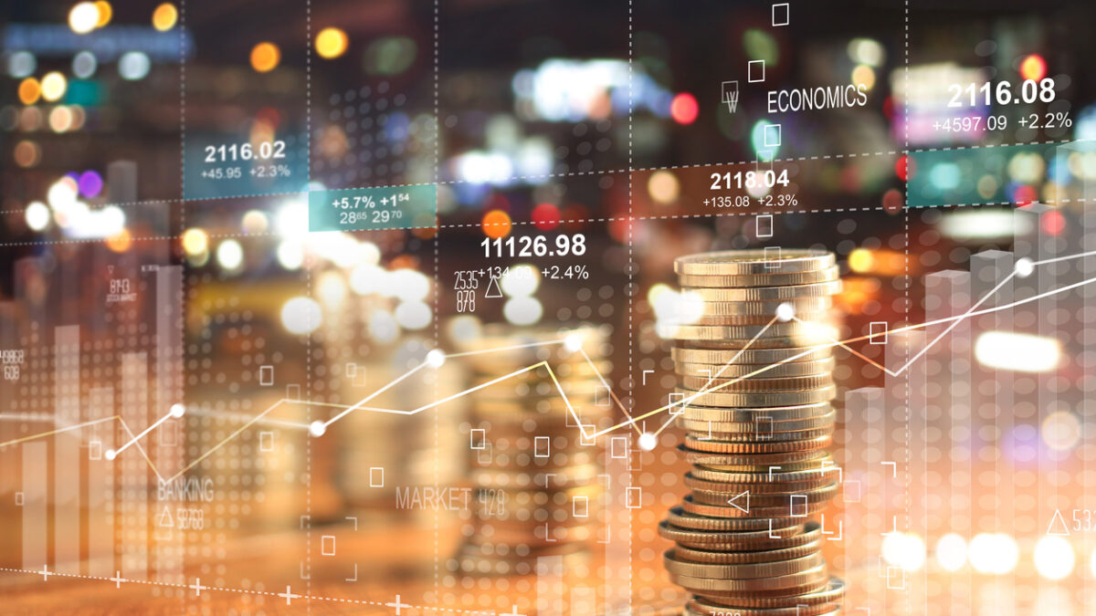 Double explosure with businesss charts of graph and rows of coins for finance at night city background.