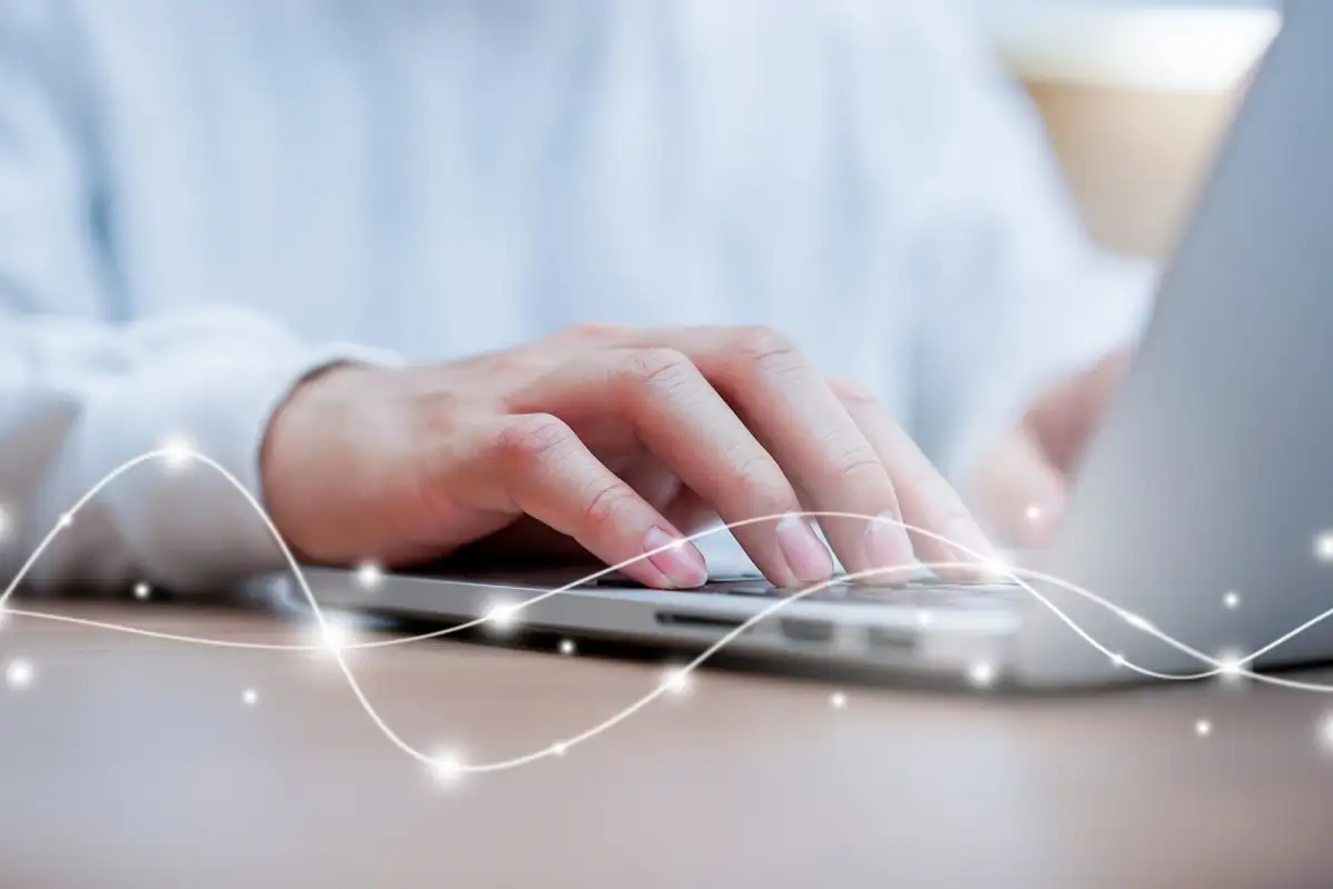 Laptop close up network man typing on keyboard laptop to access internet with virtual interface fiber optical telecommunication to exchange data information in the cyber network for business and futuristic technology communication concept