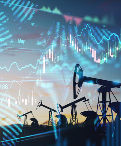 Rise in gasoline prices concept with double exposure of digital screen with financial chart graphs and oil pumps on a field