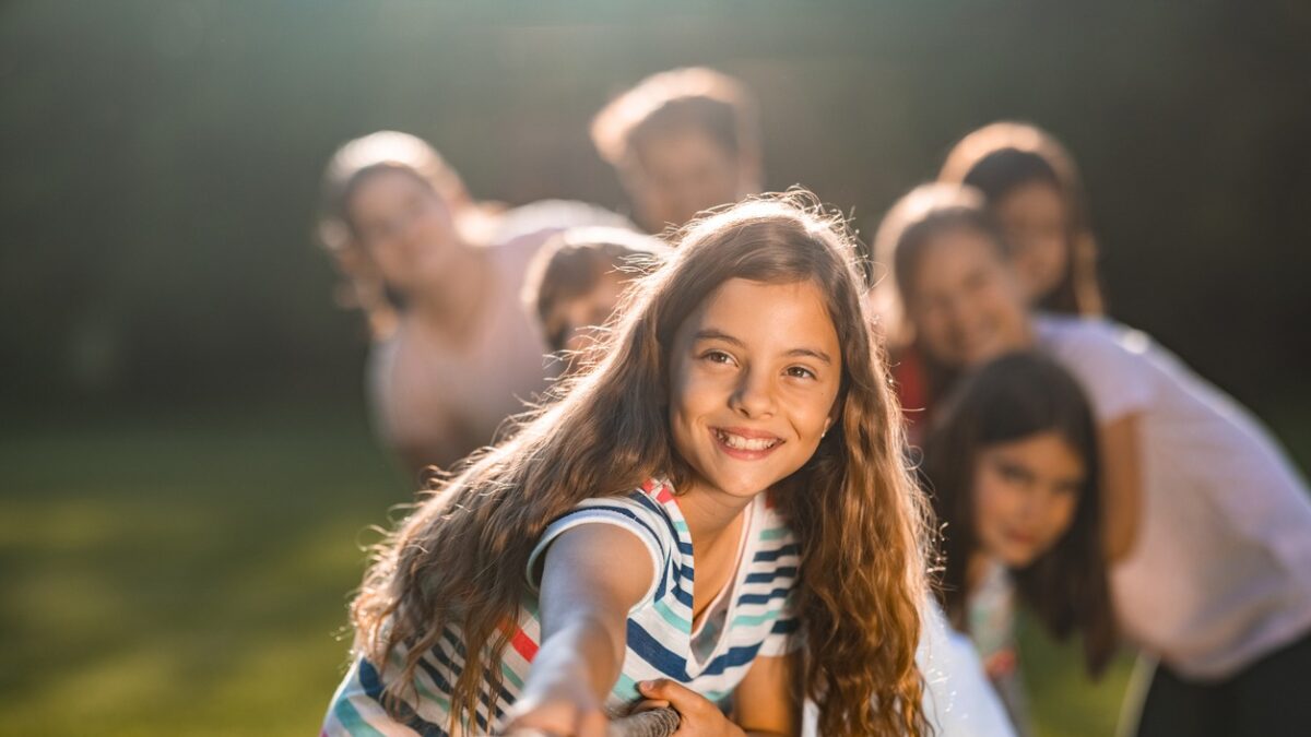 Group of children pulling a rope in public park