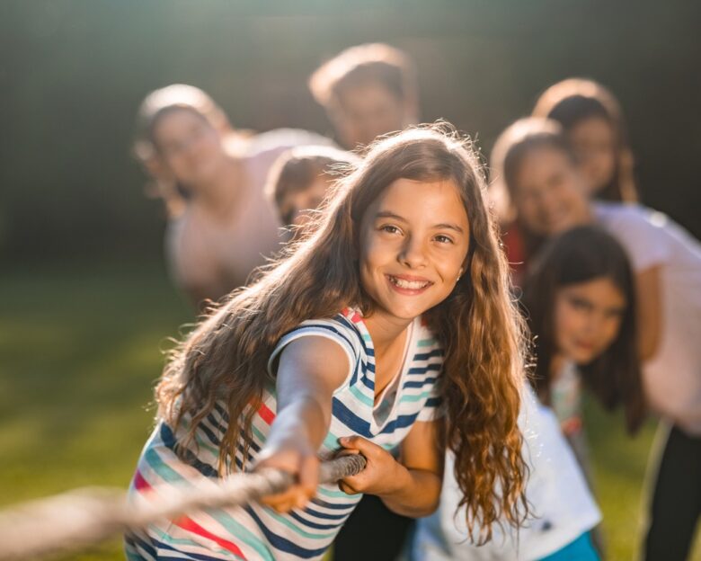 Group of children pulling a rope in public park