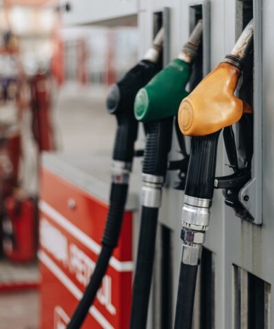 Colorful Petrol pump filling nozzles at bright sunnz day. Gas station background.