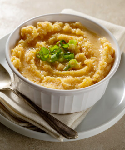 Root mash. Root vegetables mashed in a bowl. Garnished with oil and herbs