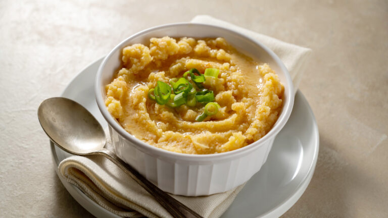 Root mash. Root vegetables mashed in a bowl. Garnished with oil and herbs