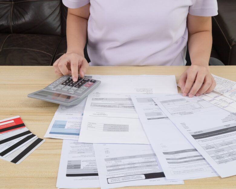 Young woman pressing the calculator for calculate the money for her dept. Asian women are stressed about payment loan problem. people with personal financial crisis concept. Debt, loan concept.