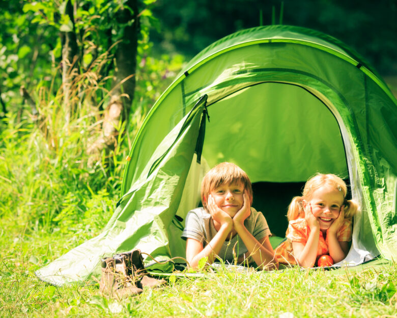 brother and sister are lying inside their tent