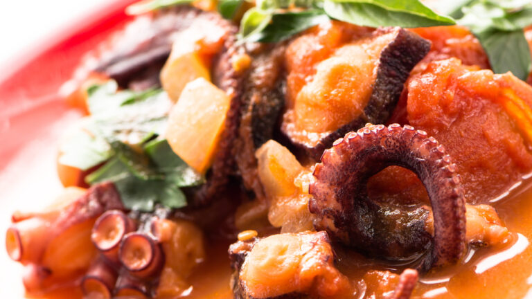 Stewed octopus in tomato sauce with parsley