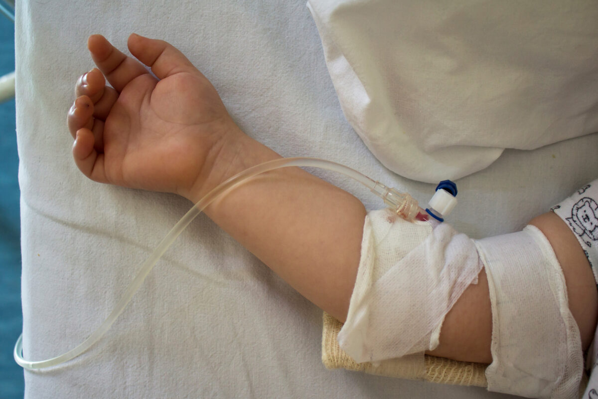Little patient, child sick in the hospital with saline intravenous (IV).Close-up. Recovery,health care treatment.