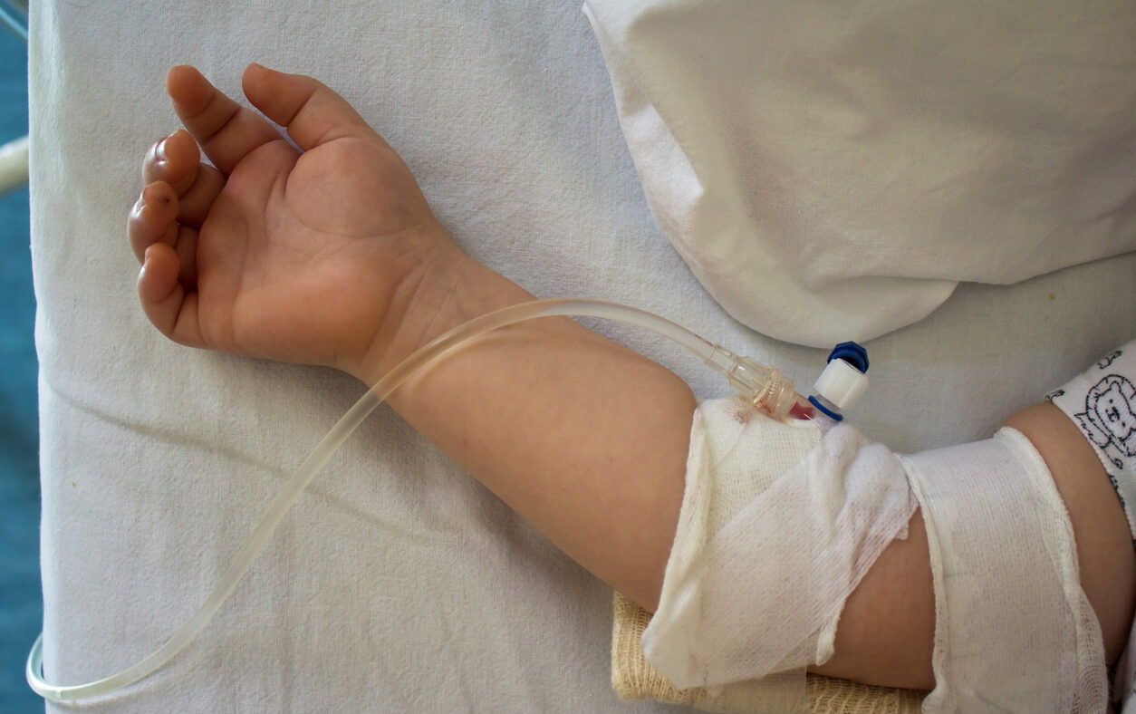Little patient, child sick in the hospital with saline intravenous (IV).Close-up. Recovery,health care treatment.