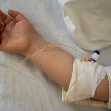 Little patient, child sick in the hospital with saline intravenous (IV).Close-up. Recovery,health care treatment.