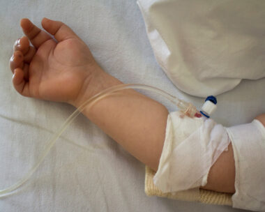 Little patient, child sick in the hospital with saline intravenous (IV).Close-up. Recovery,health care treatment.