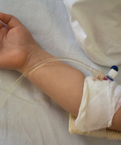 Little patient, child sick in the hospital with saline intravenous (IV).Close-up. Recovery,health care treatment.