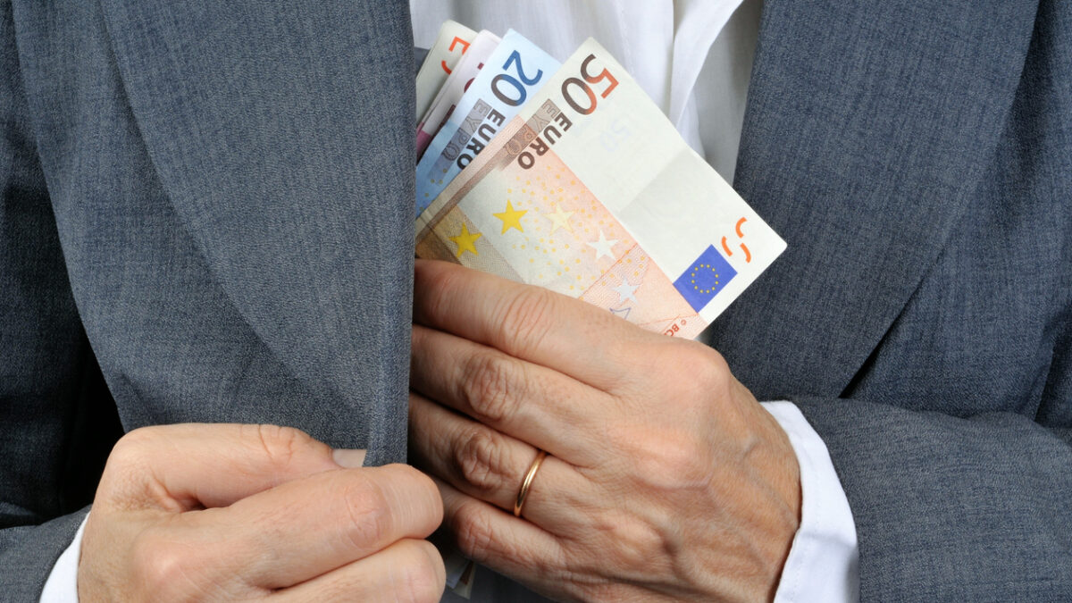 man putting money in his pocket