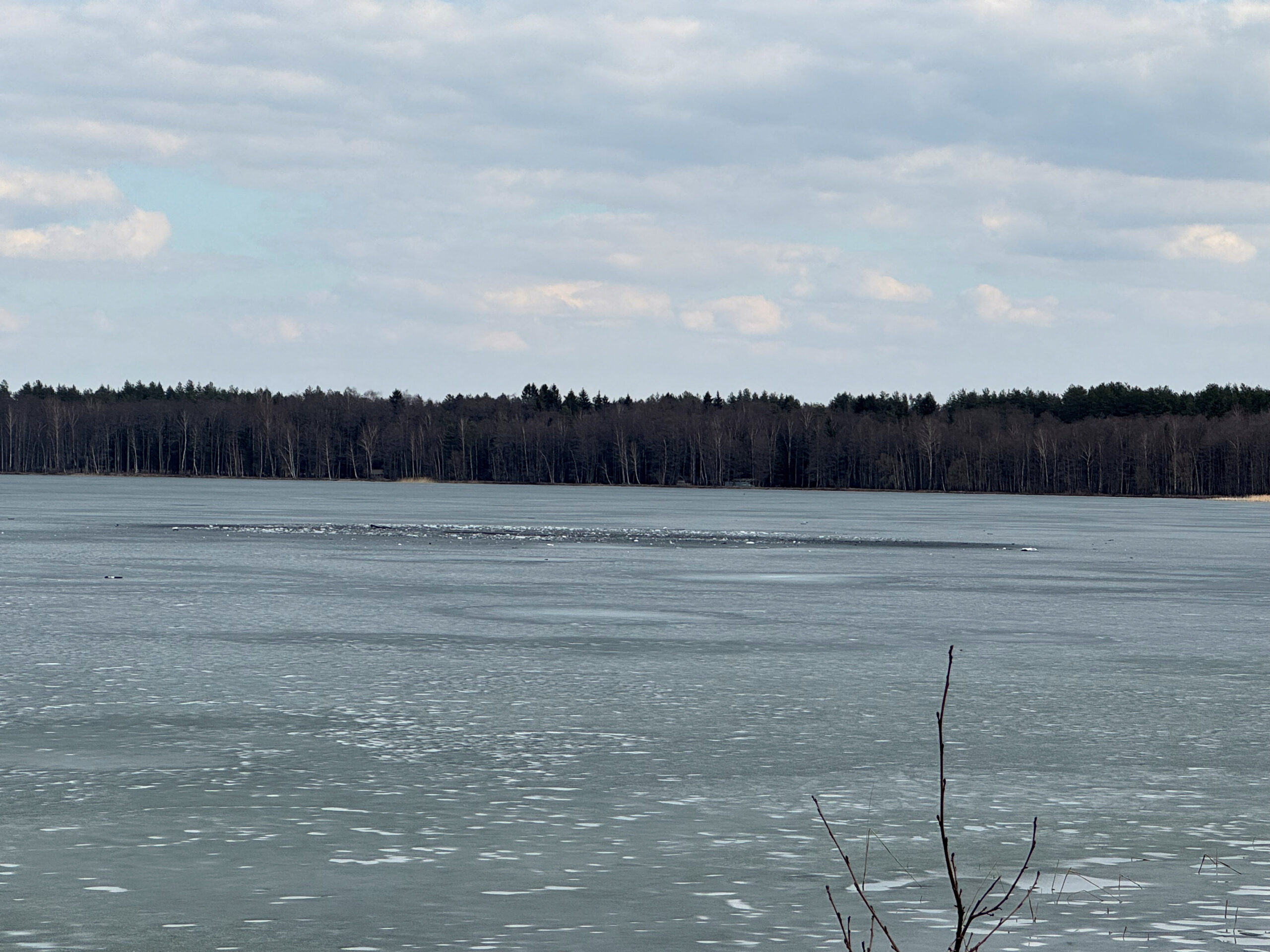 Debris lies across an ice-covered lake where Lithuania's army says that a suspected drone crashed into after entering the country's airspace, in Lavysas, Lithuania, March 23, 2026. Vytautas Lebednykas and Karolis Lebednykas/Handout via REUTERS    THIS IMAGE HAS BEEN SUPPLIED BY A THIRD PARTY. MANDATORY CREDIT.  VERIFICATION: Reuters confirmed the location as Lavysas, Lithuania by original file metadata and dock structure, vegetation and lake, which matched satellite imagery. The date when the videos were filmed was verified by original file metadata and the CCTV footage timestamp. The sound heard in CCTV footage and debris could not be identified. However, Lithuanian army said a suspected drone entered Lithuania’s airspace on March 23 and crashed into a lake 20 km from the border of Belarus