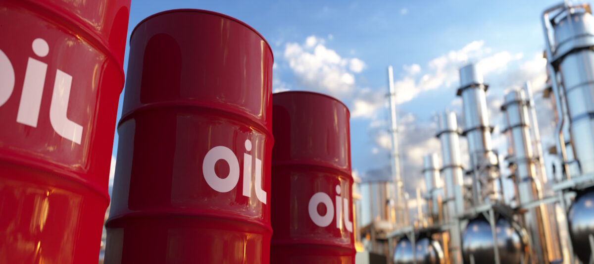 Red oil barrels at a large crude oil plant panoramic at sunset 3d render