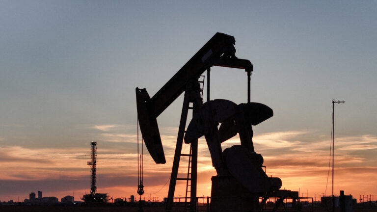 FILE PHOTO: A drone view of a pump jack and drilling rig south of Midland, Texas, U.S. June 11, 2025. REUTERS/Eli Hartman//File Photo
