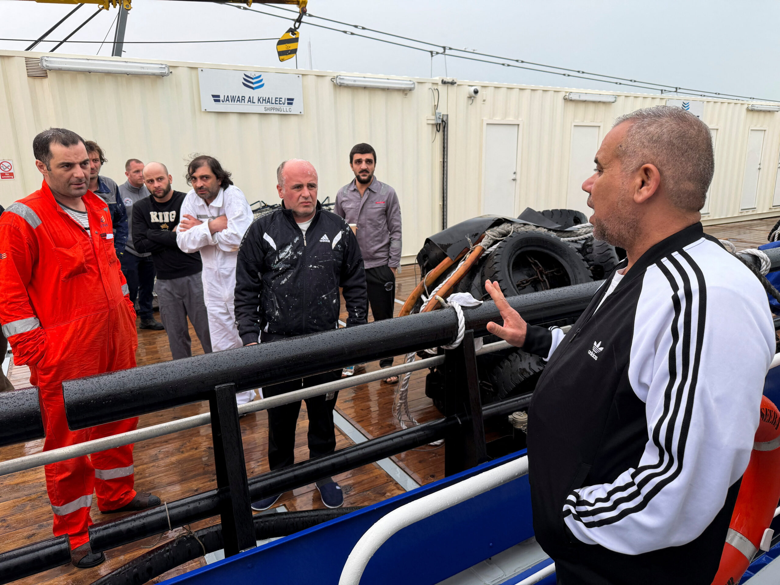 Crew members rescued from the fuel tanker Zephyros aboard an Iraqi vessel, after the tanker was set ablaze in an apparent attack in Iraqi waters, at the port of Faw Iraq's director general of the General Company for Ports Farhan al-Fartousi interacts with rescued crew members from the fuel tanker Zephyros, who are aboard an Iraqi vessel following an apparent attack on the tanker in Iraqi waters, according to port and maritime security sources, amid the U.S.-Israeli conflict with Iran, at the port of Faw, Basra province, Iraq, March 12, 2026. Picture taken with a mobile phone. REUTERS/Mohammed Aty
