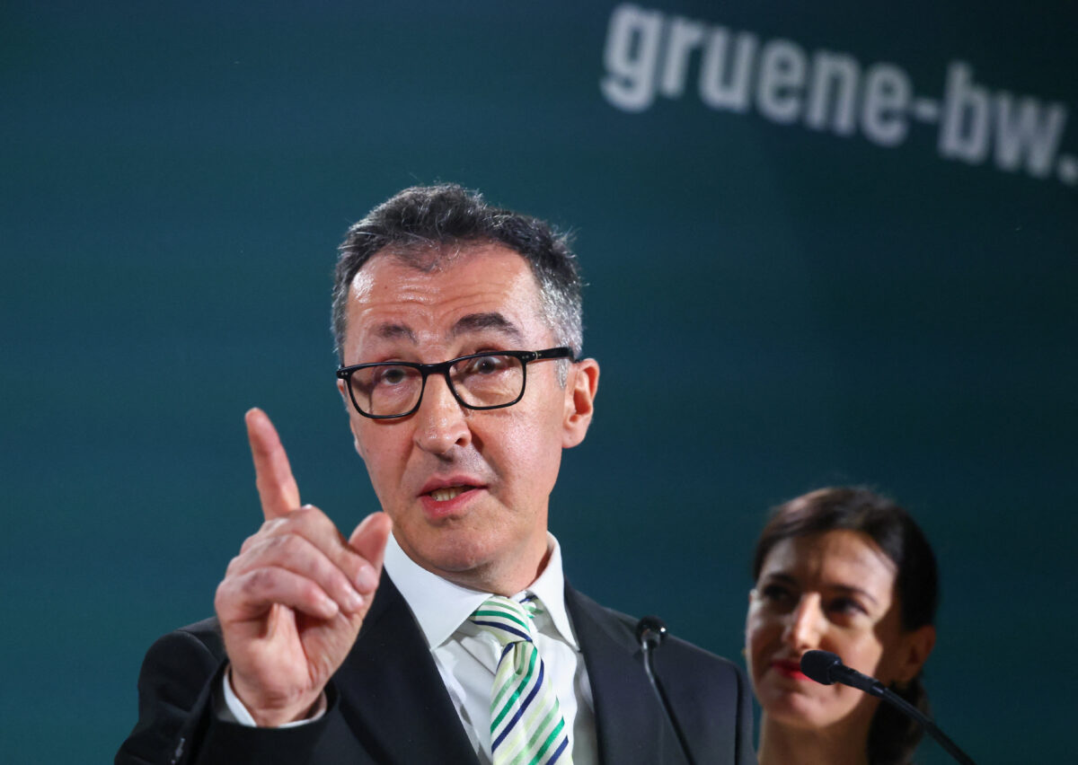 Cem Oezdemir, top candidate of the Greens party in Germany's Baden-Wuerttemberg state election, speaks next to his wife Flavia, following exit polls, in Stuttgart, Germany, March 8, 2026. REUTERS/Wolfgang Rattay