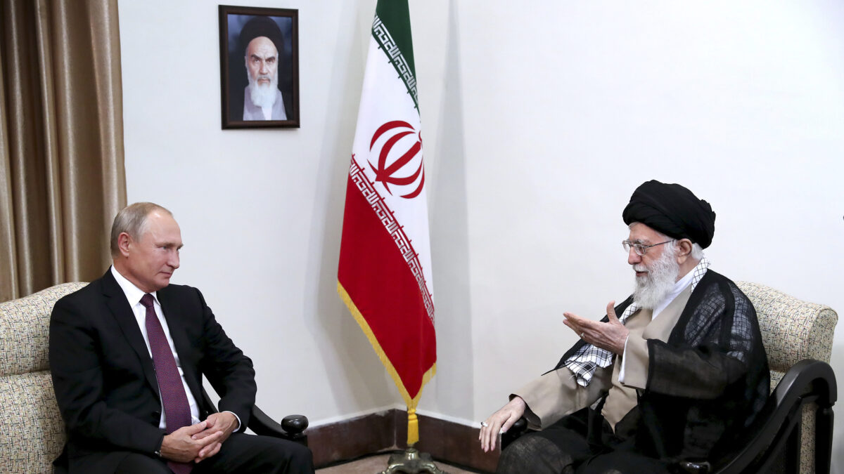 In this picture released by an official website of the office of the Iranian supreme leader, Supreme Leader Ayatollah Ali Khamenei, right, speaks with Russia's President Vladimir Putin, in Tehran, Iran, Friday, Sept. 7, 2018. A portrait of the late Iranian revolutionary founder Ayatollah Khomeini hangs on the wall. (Office of the Iranian Supreme Leader via AP)