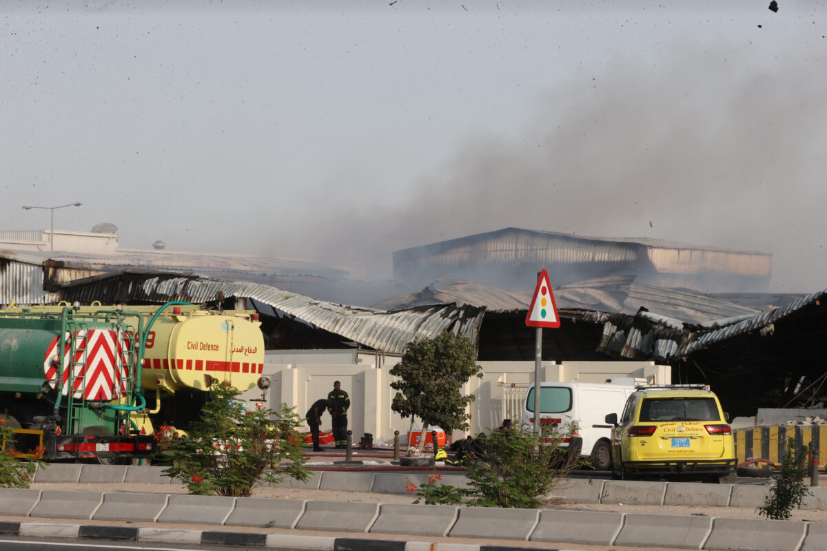 Firefighters work as smoke rises outside a damaged warehouse in an industrial area in Al Rayyan, Qatar, following an Iranian strike, Sunday, March 1, 2026. (AP Photo)