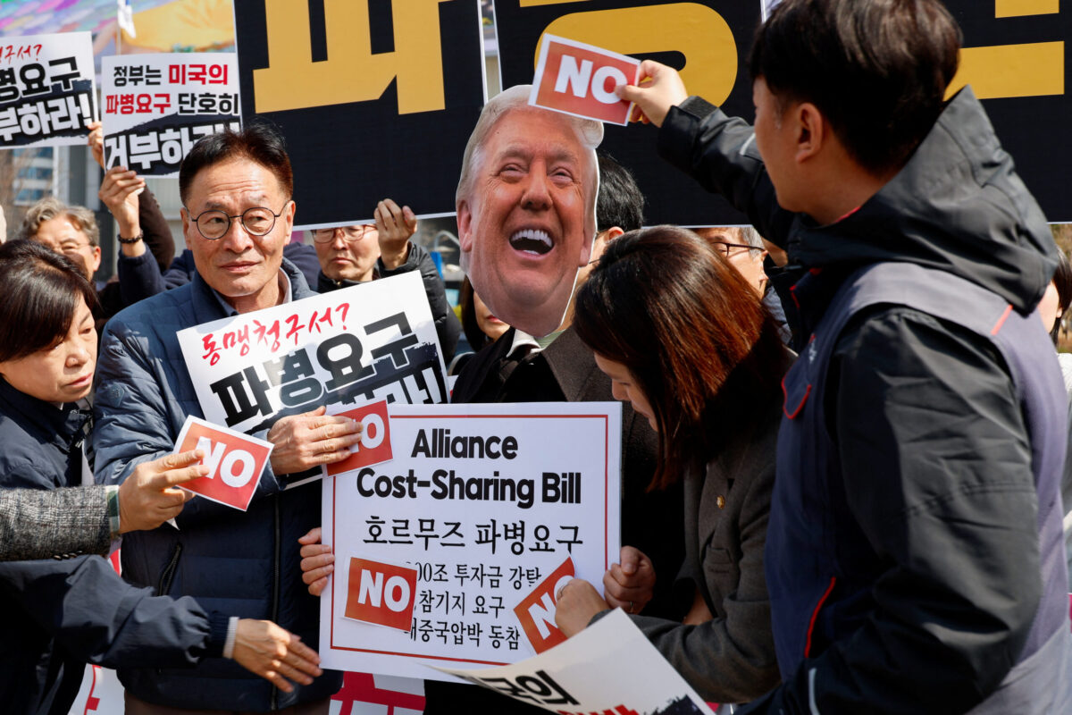 Activists hold a rally against the U.S. demand for South Korea to deploy troops to the Strait of Hormuz, in Seoul Activists place