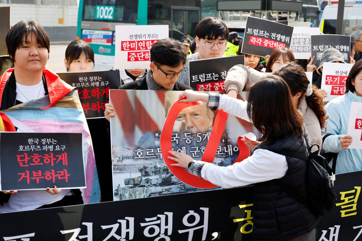 Activists hold a rally against the U.S. demand for South Korea to deploy troops to the Strait of Hormuz, in Seoul An activist puts a sticker on a placard with an image of U.S. president Donald Trump during a rally against the U.S. demand for South Korea to deploy troops to the Strait of Hormuz, outside the U.S. embassy in Seoul, South Korea, March 16, 2026. REUTERS/Kim Soo-hyeon