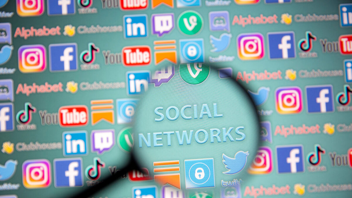 FILE PHOTO: Social network words and social media logos are seen through magnifier displayed in this illustration taken, May 25, 2021. Picture taken May 25, 2021. REUTERS/Dado Ruvic/Illustration/File Photo