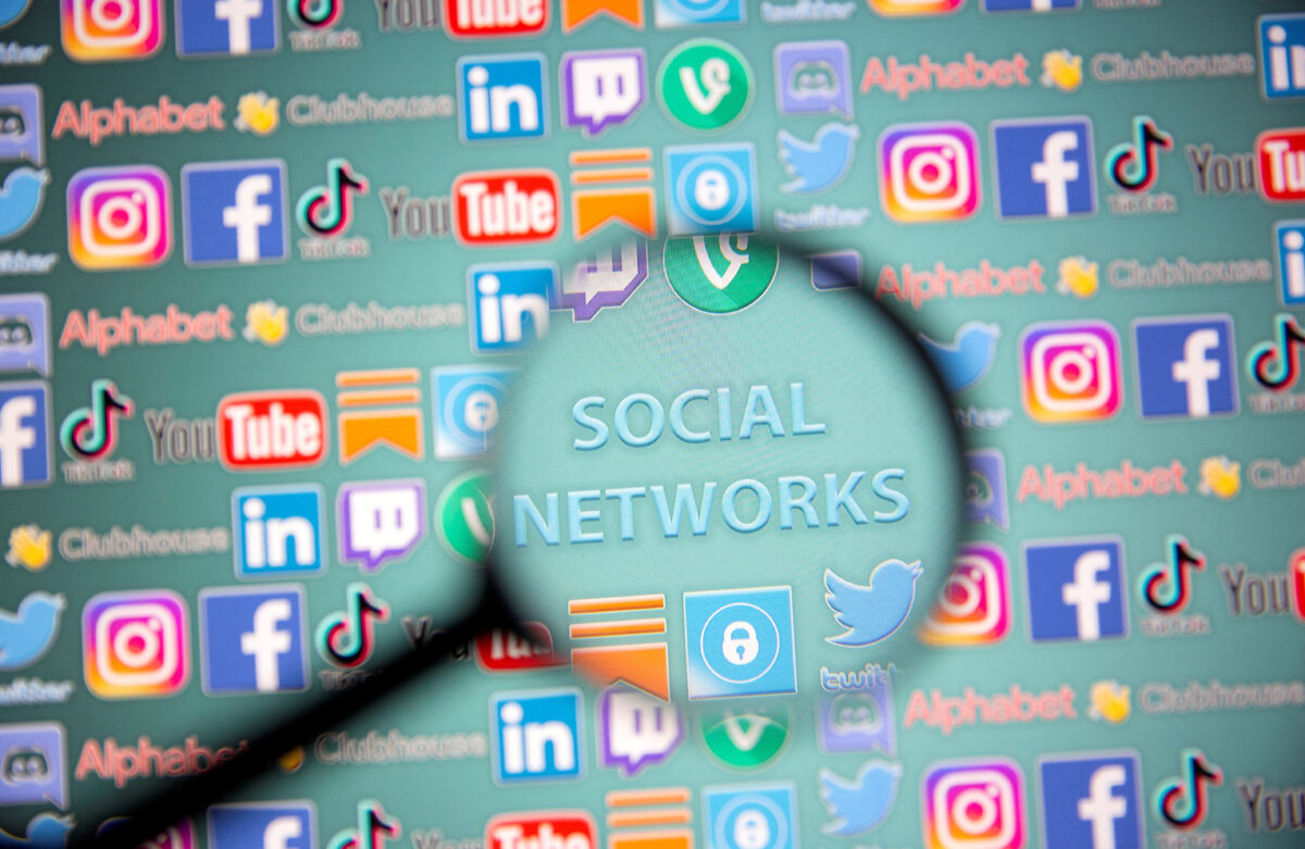 FILE PHOTO: Social network words and social media logos are seen through magnifier displayed in this illustration taken, May 25, 2021. Picture taken May 25, 2021. REUTERS/Dado Ruvic/Illustration/File Photo