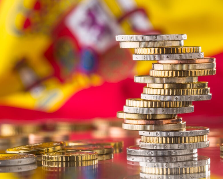 National flag of spain and euro coins - concept. Euro coins. Euro money. Euro currency.