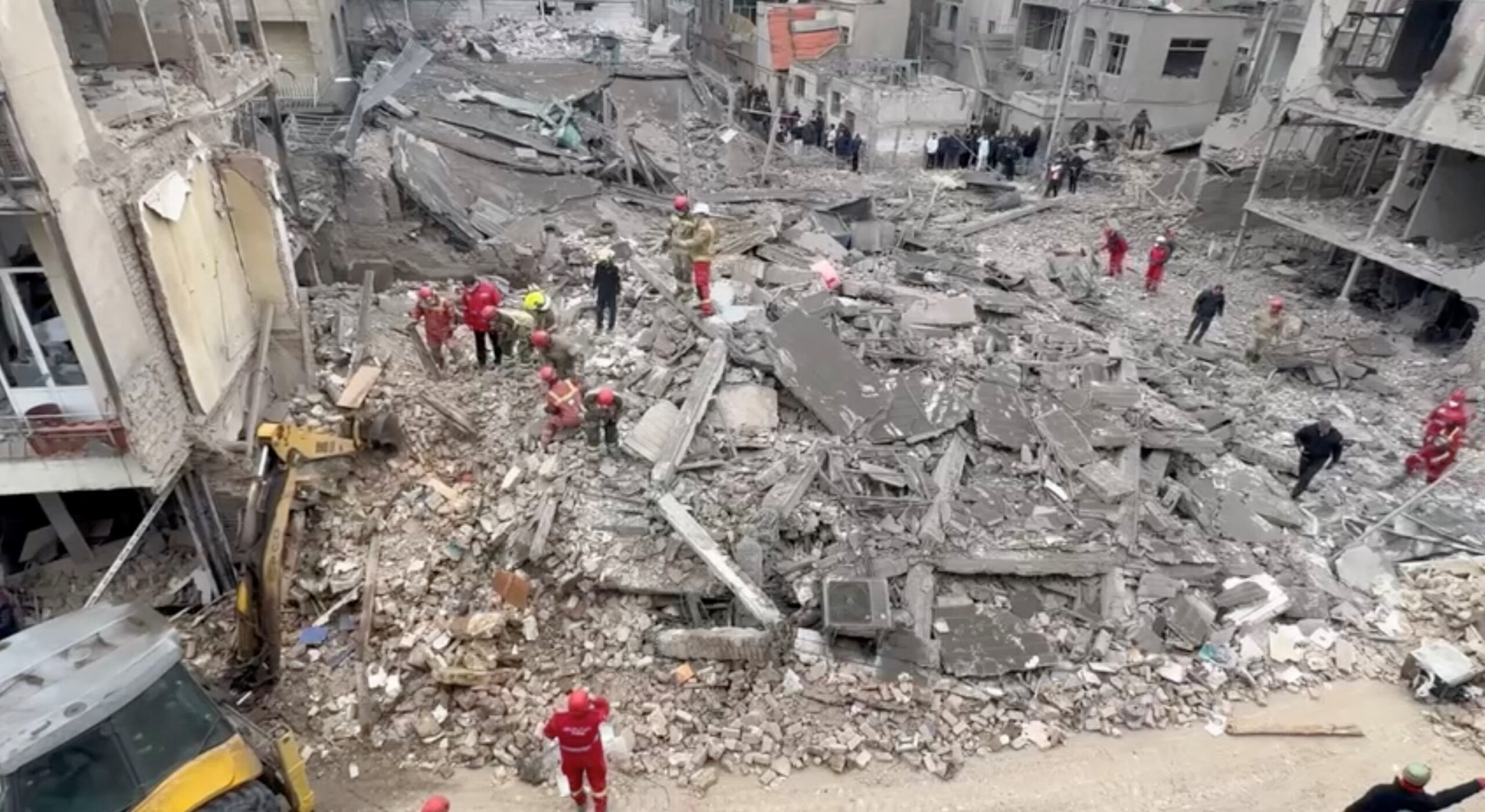 Aftermath of strike in Javadiyeh district, Tehran Iranian Red Crescent aid workers and firefighters work at a residential site damaged by strikes, in Javadiyeh district, Tehran, Iran, in this still image obtained from a video released March 14, 2026. Iranian Red Crescent Society/Handout via REUTERS THIS IMAGE HAS BEEN SUPPLIED BY A THIRD PARTY. NO RESALES. NO ARCHIVES. MANDATORY CREDIT. VERIFICATION: Reuters confirmed the location as Javadiyeh district, Tehran by the buildings, road layout, and highway divider which matched file and satellite imagery and another video verified by Reuters. Coordinates: 35.647908748581706, 51.395776192302044. The date when the video was recorded could not be independently verified, but local Iranian media reported that residential neighbourhoods of Beryanak and Javadiyeh in southeastern Tehran were struck by the United States and Israel during marches on March 13.