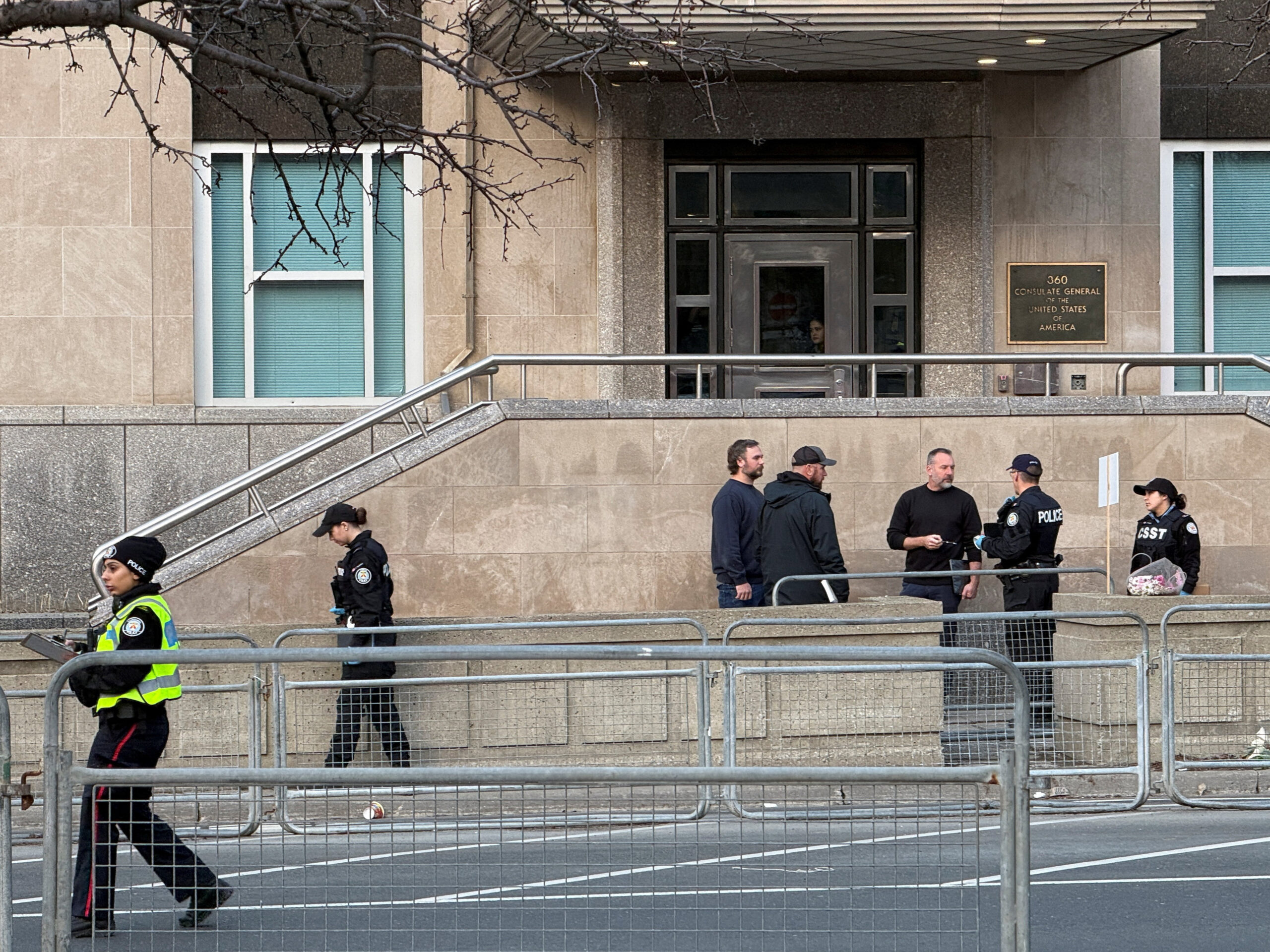 Law enforcement personnel survey the scene outside the U.S. Consulate after shots were fired, in Toronto, Ontario, Canada, March 10, 2026. Picture taken with a mobile phone. REUTERS/Kyaw Soe Oo