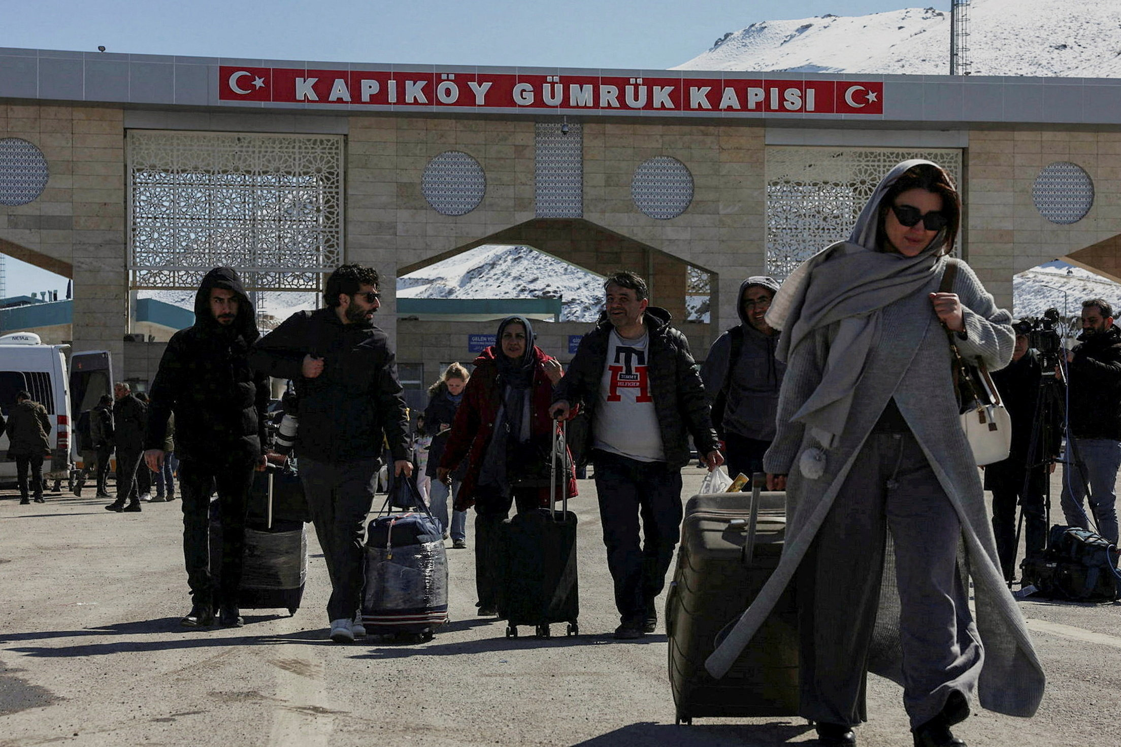 WIDER IMAGE: ‘Maybe we die together’: Voices at the Iran-Turkey mountain crossing Iranians make their way after crossing into Turkey at the Kapikoy Border Gate in the eastern Van province, Turkey, March 3, 2026. REUTERS/Dilara Senkaya SEARCH