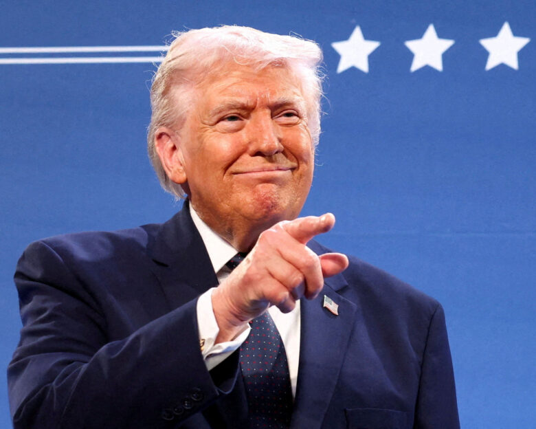 U.S. President Donald Trump gestures from the stage next to U.S. Representative Steve Scalise (R-LA) at Trump National Doral Miami in Miami, Florida, U.S., March 9, 2026. REUTERS/Kevin Lamarque TPX IMAGES OF THE DAY
